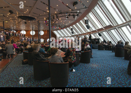 Finns watching the entertainment onboard the Helsinki to Tallinn cruise ship Stock Photo