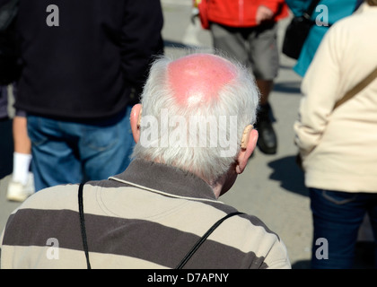 a rear view of an elderly man with a bald head Stock Photo