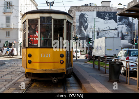 Street scene in Milan with tram and Giorgio Armani advertising poster Stock Photo