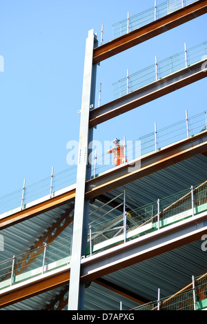 A construction worker looks on from a new build housing project. Stock Photo