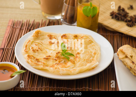roti canai and teh tarik, very famous drink and food in malaysia Stock Photo