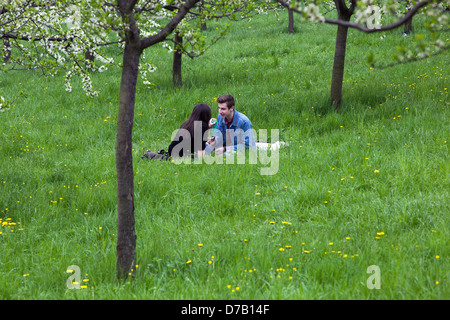 Romantic walk on the Petrin hill, Prague Czech Republic couple sitting in grass park Stock Photo