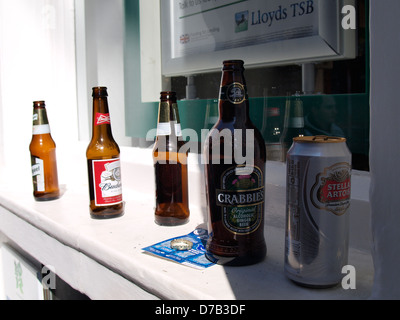 Empty beer bottles left on a banks window sill, UK 2013 Stock Photo