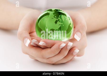 Green globe in hands Stock Photo