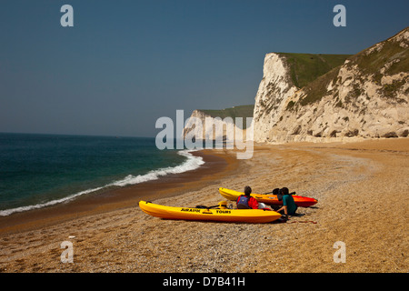 Sea kayaks on the beach at Durdle Door on the SW Heritage Coast, Dorset, England, UK Stock Photo