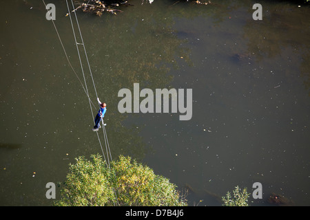 A boy is climbing over river Alzette, Luxembourg, Europe Stock Photo