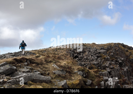 A walker ascending on the Pony Path on the welsh mountain Cadair Idris in Snowdonia National Park, Gwynedd, Wales, April 2013 Stock Photo