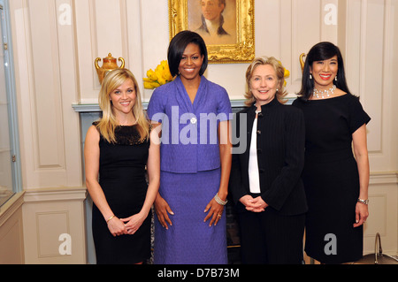 US Secretary of State Hillary Rodham Clinton stands with actress Reese Witherspoon, First Lady Michelle Obama, and Avon Chairwoman and CEO Andrea Jung at the 2010 International Women of Courage Awards at the US Department of State March 10, 2010 in Washington, DC. Stock Photo