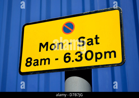 British Traffic sign: No Stopping / Parking - Mon-Sat 8am-6.30pm Stock Photo