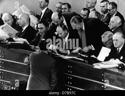 Defence minister Theodor Blank (M) discusses with his consultants about the conscription law. The Bundestag had passed the law on the 7th of July in 1956 after sixteen hours of debate. Stock Photo