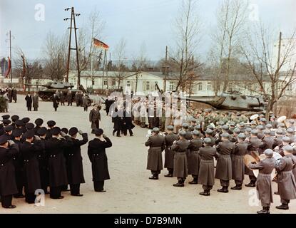 German chancellor Konrad Adenauer (M, l) and defence minister Theodor Blank (not identified) walk past a lined-up front of soldiers in Andernach on the 20th of January in 1956. Adenauer visited a didactic company of the armed forces, the air force and navy in the first garrison town of the new Federal Armed Forces in Andernach. Stock Photo