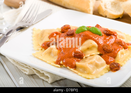 Ravioli - Italian egg pasta with chicken and chorizo filling with creamy tomato and chorizo butter sauce. Stock Photo