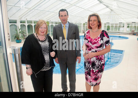 Llandrindod Wells, UK. 3rd May 2013. Edwina Hart and the owners pose for photos in the indoor pool. Owners, Justin Baird-Murray and his sister Sarah Hill have overseen a £5 million refurbishement of The Metropole Hotel, resulting in an upgrade to its current four-star status. A six figure sum was secured to carry out the new spa development supported by Barclays. Edwina Hart, Minister for Economy, Sciences & Transport said, “The tourism sector is one of our key growth markets and is worth £5 billion to the Welsh economy.” Photo Credit: Graham M. Lawrence/Alamy Live News. Stock Photo