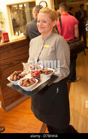 Llandrindod Wells, UK. 3rd May 2013. A waitress serves canapes. Owners, Justin Baird-Murray and his sister Sarah Hill have overseen a £5 million refurbishement of The Metropole Hotel, resulting in an upgrade to its current four-star status. A six figure sum was secured to carry out the new spa development supported by Barclays. Edwina Hart, Minister for Economy, Sciences & Transport said, “The tourism sector is one of our key growth markets and is worth £5 billion to the Welsh economy.” Photo Credit: Graham M. Lawrence/Alamy Live News. Stock Photo