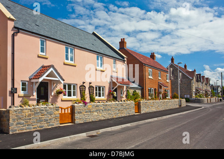 An estate of new build houses in the style and colours of traditional village cottages. Cossington, Somerset, England, UK Stock Photo