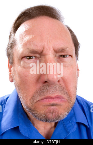 Face of angry senior adult man with Parkinsons disease as he stares with a threatening look. Stock Photo