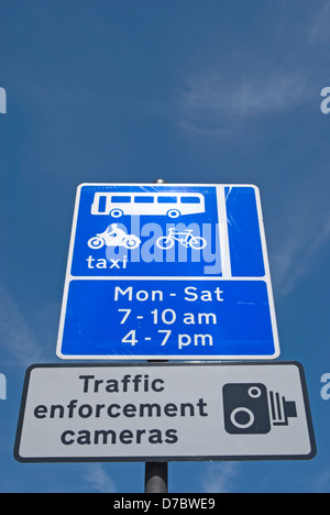 british road signs indicating traffic enforcement cameras and taxi, cycle and bus lane restrictions Stock Photo