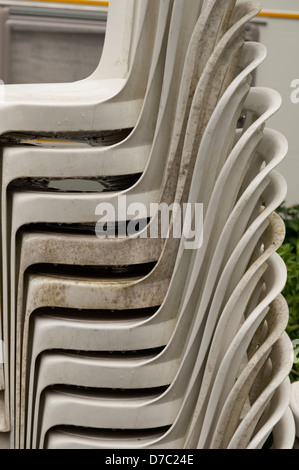 Stacked plastic tables & Chairs wet dirty raining Zonhoven Belgium Europe EU Stock Photo