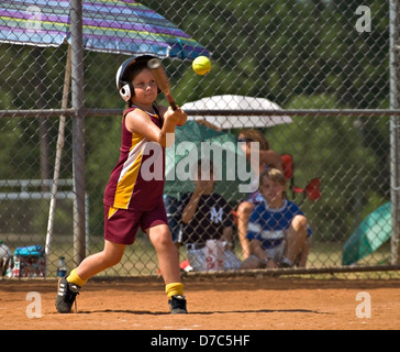 Young Girl Making a Hit in a Softball Game Stock Photo