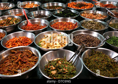 Metal bowls full of various fermented vegetables (kimchi). Photo taken on a Korean traditional food market in Suwon, South Korea Stock Photo