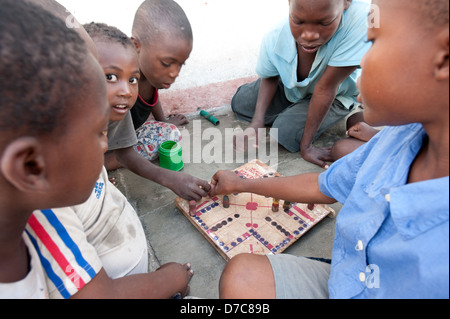 boys playing a boardgame on the street, Ilha do Mocambique, Mozambique Stock Photo