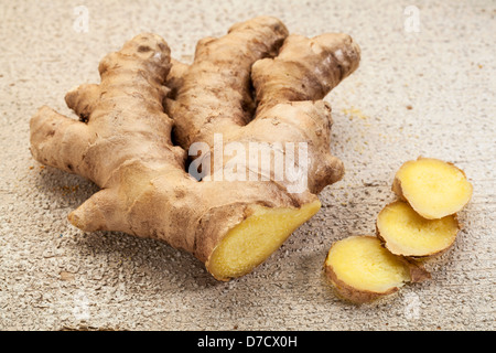 ginger root slices on a rustic white painted barn wood background Stock Photo