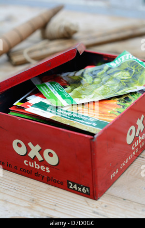 Old 'OXO' tin containing seed packets Stock Photo