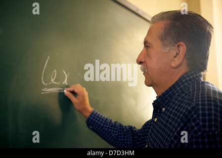 People and education, professor writing on board during lesson in college, Law School, University of Havana, Cuba Stock Photo