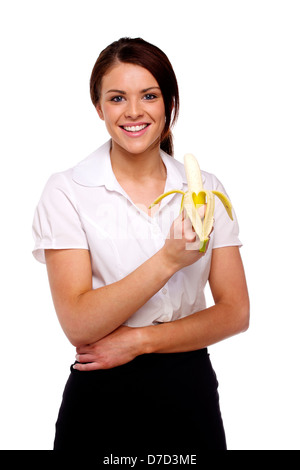 Beautiful brunette business woman holding a banana isolated on a white background Stock Photo