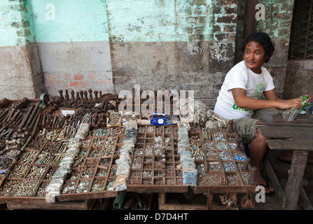 Man selling nuts and bolts in the Indian Market, Yangon Myanmar Stock Photo