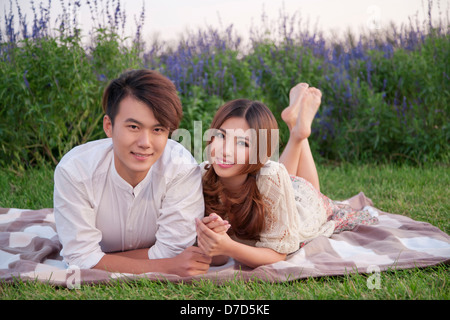 Young couple lying on a blanket on the lens Stock Photo