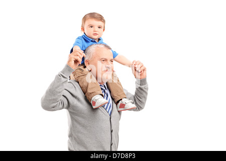 Senior giving a piggy back ride to his grandson isolated on white background Stock Photo