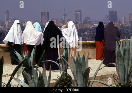 Muslim women wearing traditional Niqab headscarf gazing from Saladin or Salaḥ ad-Dīn Citadel a medieval Islamic fortification located on Mokattam hill in Cairo, Egypt Stock Photo