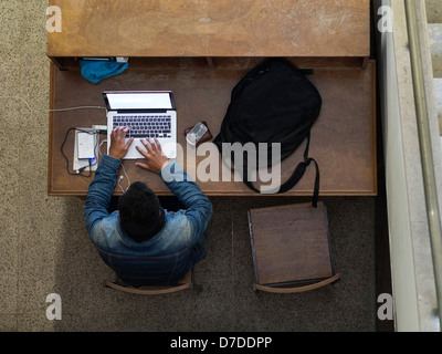 Overhead view of man using laptop computer Stock Photo