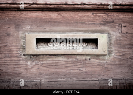 Letters slot at Old Wooden Door in Lisbon, Portugal. Correio letters are on the front Stock Photo