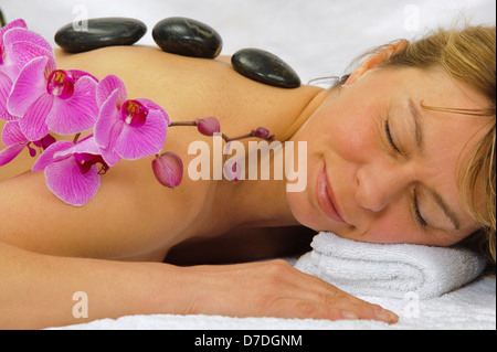 spa with massage stones and orchid flower Stock Photo