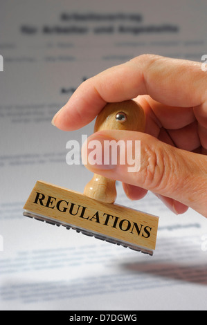 regulations marked on rubber stamp Stock Photo