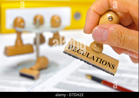 regulations marked on rubber stamp Stock Photo