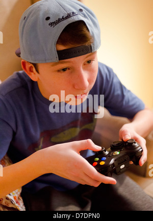 Teenage Boy playing Xbox 360 Video Game. Stock Photo