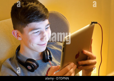 Teenage Boy using Apple Ipad. Stock Photo