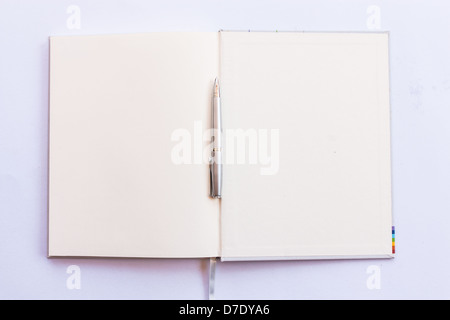 Open book with pen in blank last pages. isolated with white background Stock Photo
