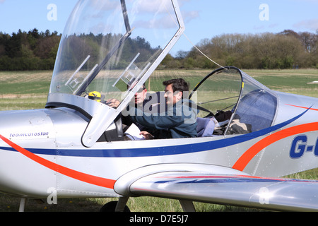 Flying pilot instructor and student passenger in a light aircraft at a grass airfield UK Stock Photo