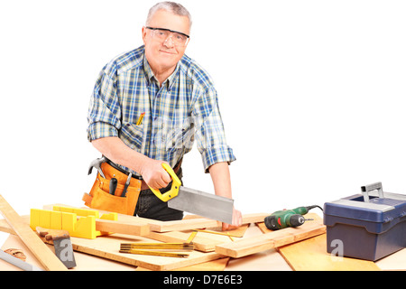 Middle aged male carpenter working in a workshop isolated on white background Stock Photo
