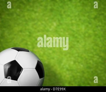 green grass soccer field and ball background Stock Photo