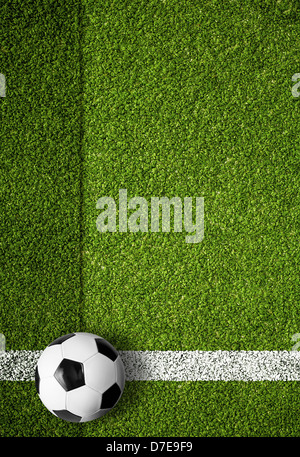 soccer ball on white marking line, edge of football field Stock Photo