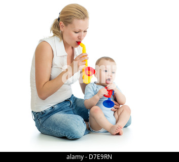 Mother and baby boy having fun with musical toys Stock Photo