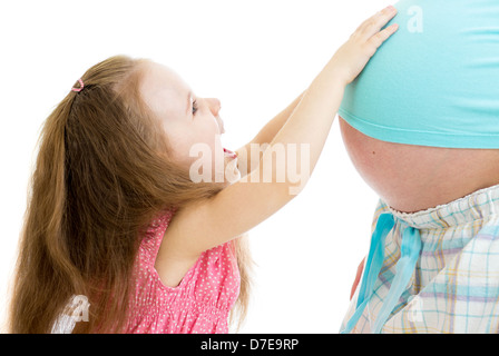 kid girl touches pregnant mother's belly isolated Stock Photo