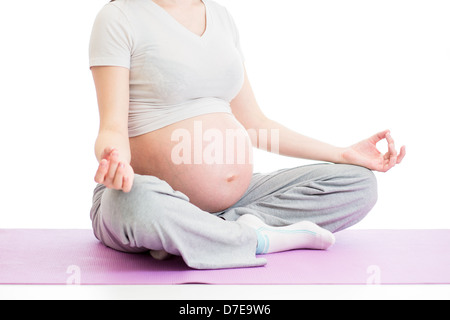 pregnant woman sitting in yoga lotus position Stock Photo
