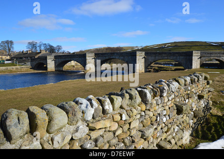 The five arched road bridge over the River Wharfe in Burnsall on the Dales Way Long Distance Footpath Wharfedale Yorkshire Stock Photo