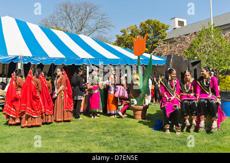 Hempstead, New York, USA. 5th May 2013. By a very tall wooden tulip, Indian female dancers are ready to share the rich heritage of India in dance, at the 30th Annual Dutch Festival celebrating Hofsta University's Global Campus. The performers wear traditional makeup, gold jewelry, and colorful silk costumes, and will perform on stage in the big tent. Credit:  Ann E Parry / Alamy Live News Stock Photo